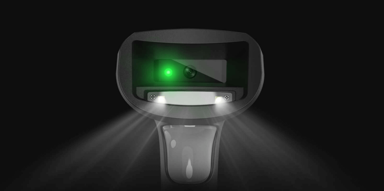 A person operating a barcode printer connected to a computer in a clean workspace.